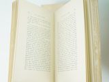 a person holding an open book in their hand