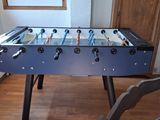 a foosball table in the corner of a living room