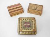three small wooden boxes sitting on top of a white surface