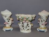 three porcelain vases with cherries and cherries on them on a table