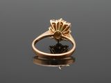 an image of a gold ring with a green stone
