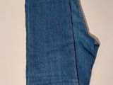 a pair of blue jeans sitting on top of a white table