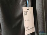 the back of a black jacket with a tag attached to it