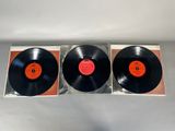 two black vinyl records sitting on top of each other on a table