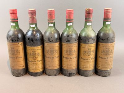 six bottles of wine are lined up in a row on a table