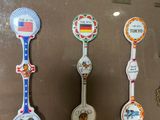 many spoons and spoon spoons on display in a glass case