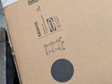 a cardboard box with a black dot on it