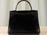 an image of a black handbag on a wooden table