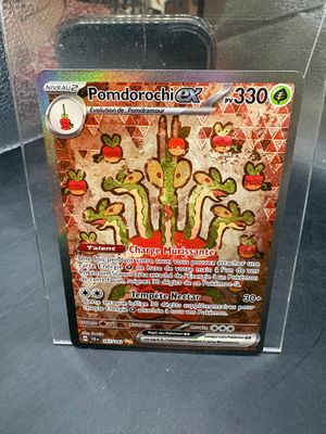 a pokemon card in a clear box on a table
