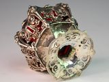 a silver ring with a red stone inside of it