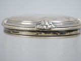 a close up of a silver plate with a flower on it