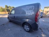a grey van parked in a parking lot next to a building