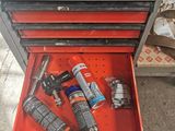 a red tool box with tools in it on the floor