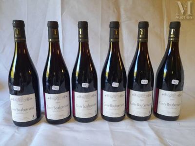 six bottles of wine are lined up in a row on a table