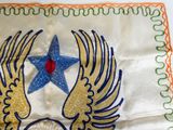 a white table cloth with a blue star and two wings on it