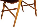 a wooden desk with a chair and a laptop on it