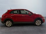 the small red car is parked in the room on the concrete floor