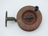 a small metal object that is sitting on a white surface