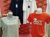 three shirts that are on display in a store