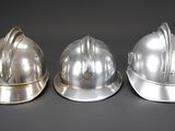 three different types of helmets sitting on a table