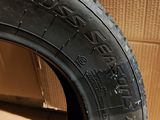a close up of a tire on a wooden floor with a cardboard box in the background