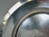 a close up of a silver plate on a table