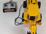 a yellow toy truck that is connected to a charger