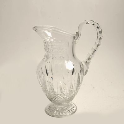 a glass pitcher that is sitting on a table