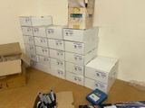 many boxes of pens and other office supplies on the floor