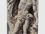 statue of a man holding a flower in his right hand