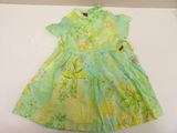 baby girl ' s green floral dress on a white table
