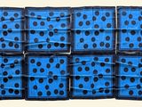 six blue and black polka dot napkins stacked on top of each other