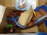 a cardboard box with a toy boat inside of it