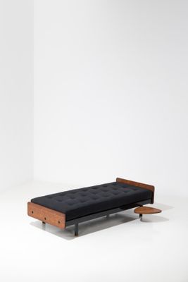 an image of a bench made out of wood and black fabric