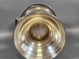 an antique silver plated cup on a grey background