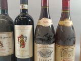 several bottles of wine are lined up in a row on a table