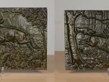 three square pieces of art on a wooden table with a white wall in the background