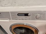 an image of a washing machine sitting on top of a dryer