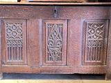 a wooden chest with carvings on the front of it