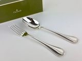 two forks and a spoon sitting next to a green box
