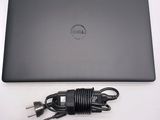 a dell laptop with a charger attached to it