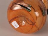 a glass vase with a design on it on a table
