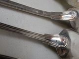 four spoons that are sitting on a table