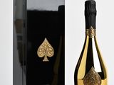 an image of a bottle of champagne sitting next to a black box