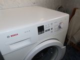a white washer and a dryer in a small room