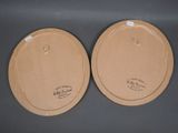 pair of brown paper plates with white labels on them sitting on a table