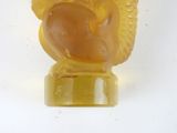 a yellow owl figurine sitting on top of a white table