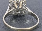 a close up view of a diamond ring on a table