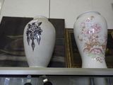 two vases sitting on a shelf in a room