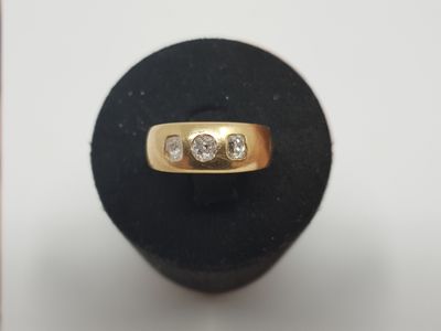 an image of a gold ring with three diamonds on top of it